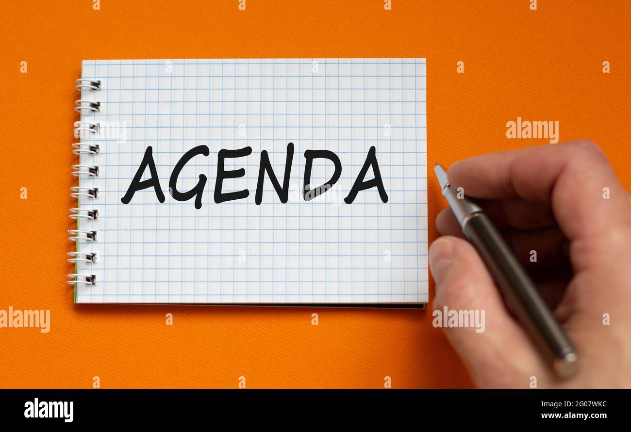 Agenda symbol. Businessman writing the concept word 'agenda', on white note  on beautiful orange background. Business and agenda concept, copy space  Stock Photo - Alamy