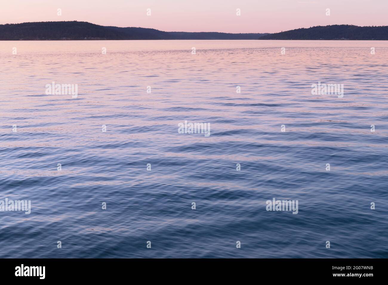 Pink Sunset Reflecting In Water Stock Photo - Alamy