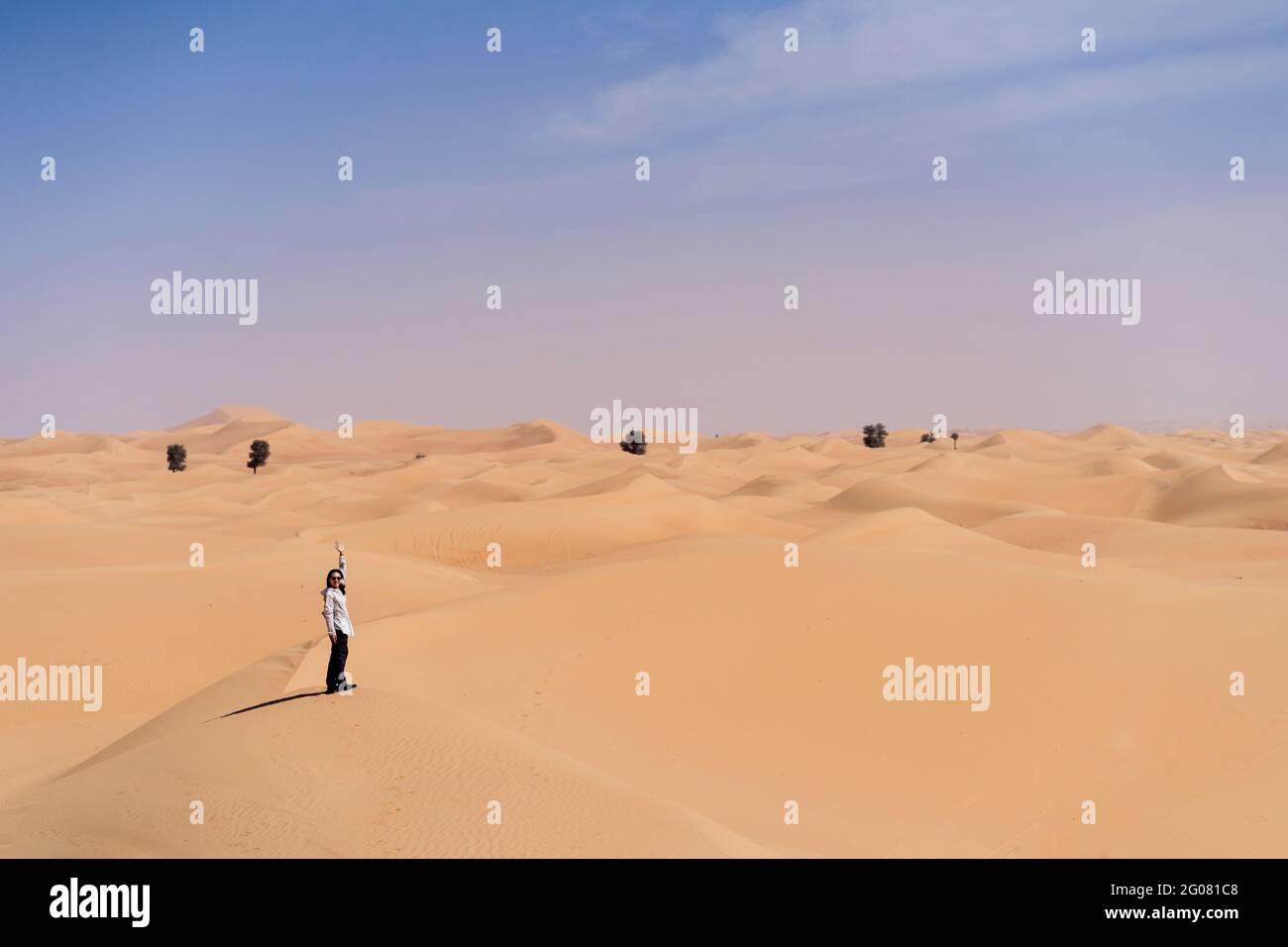 Woman waving in desert hi-res stock photography and images - Alamy