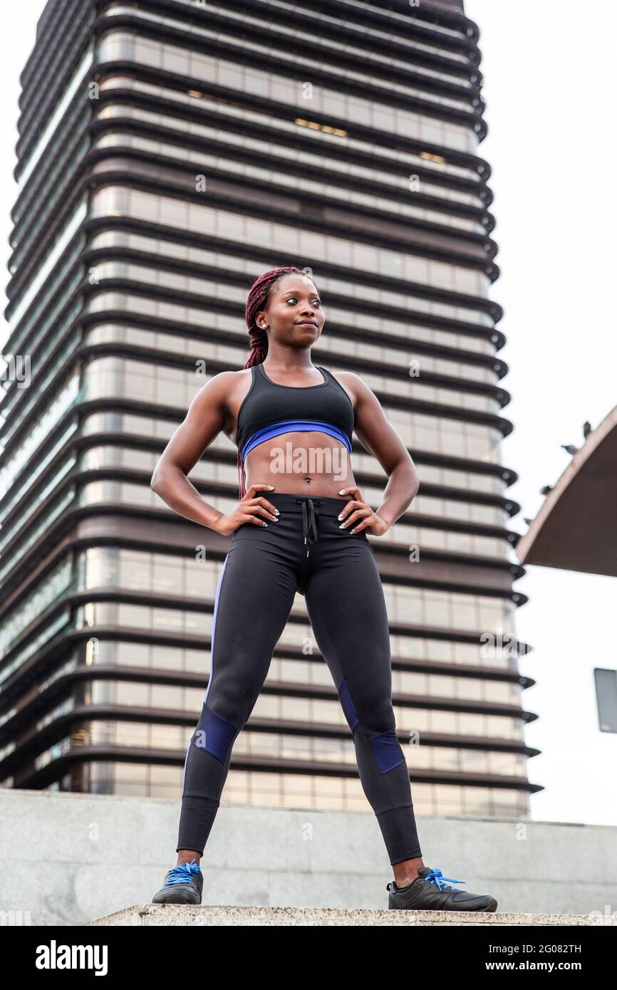 Muscular Woman posing in city Stock Photo