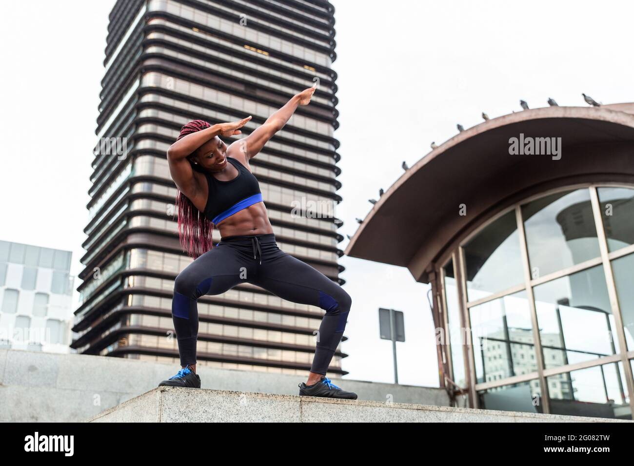 Muscular Woman posing in city Stock Photo