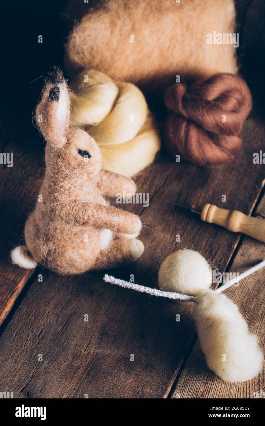 Hand made easter rabbit made of wool and felt on dark wooden table Stock Photo