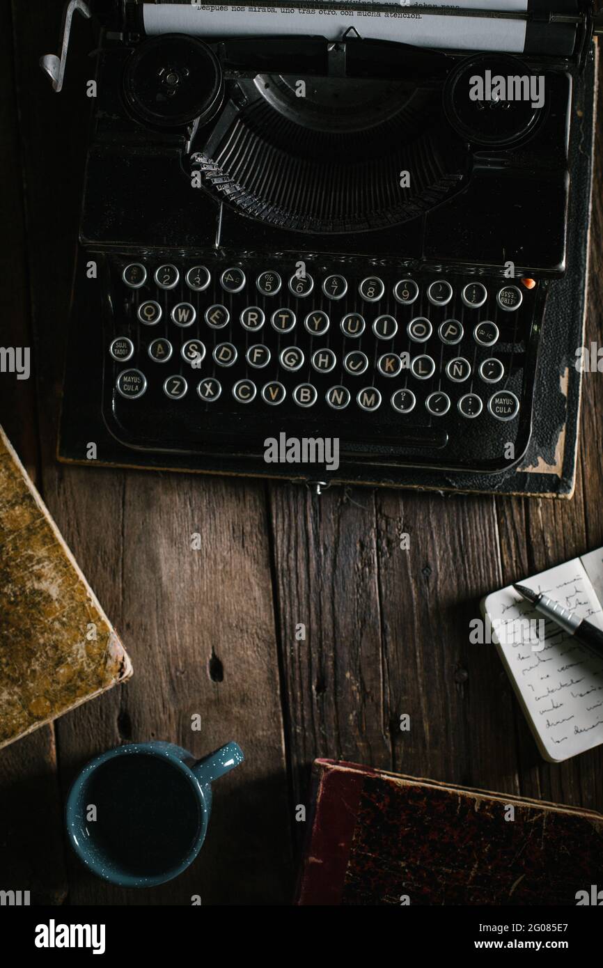 Retro vintage typewriter standing on old wooden table Stock Photo