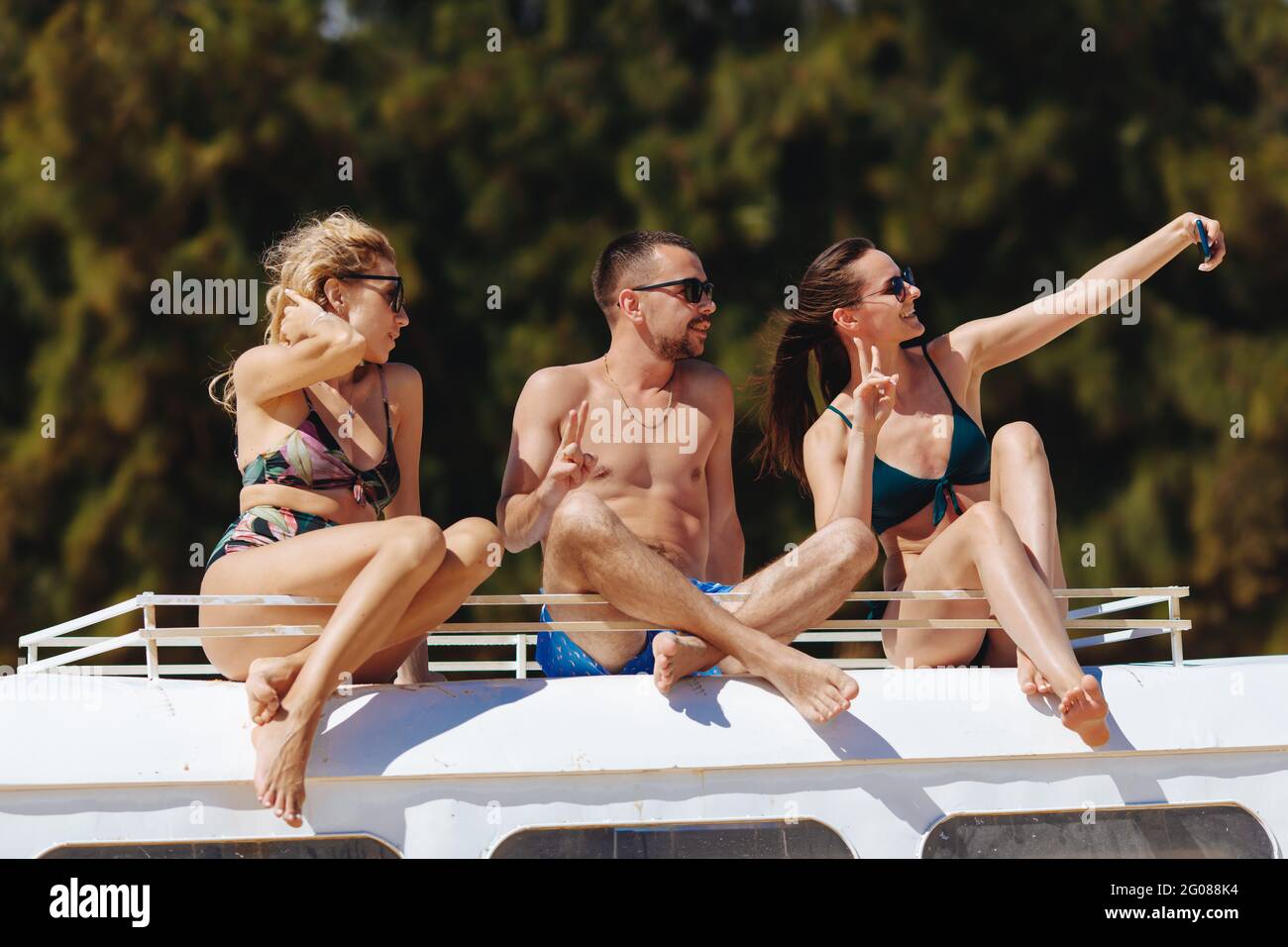 Group of tourists taking photos with smartphone on beach Stock Photo