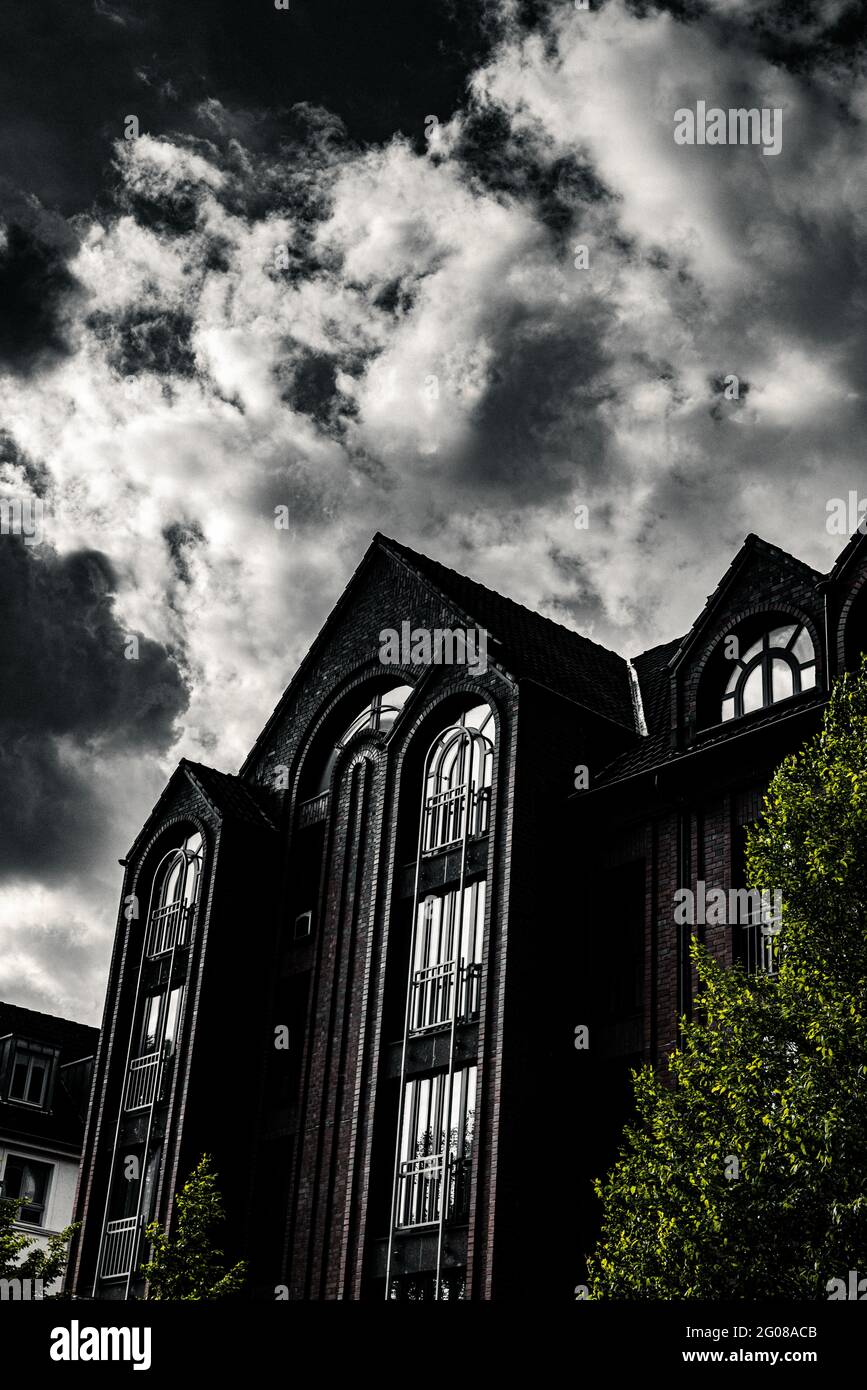 Vertical shot of a residential building with balconies under a cloudy ...