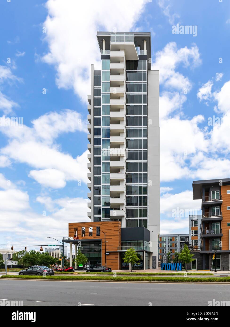 CHARLOTTE, NC, USA-30 MAY 2021: The Uptown 550 on Stonewall Apartment tower, set against blue sky and cumulus white clouds. Stock Photo