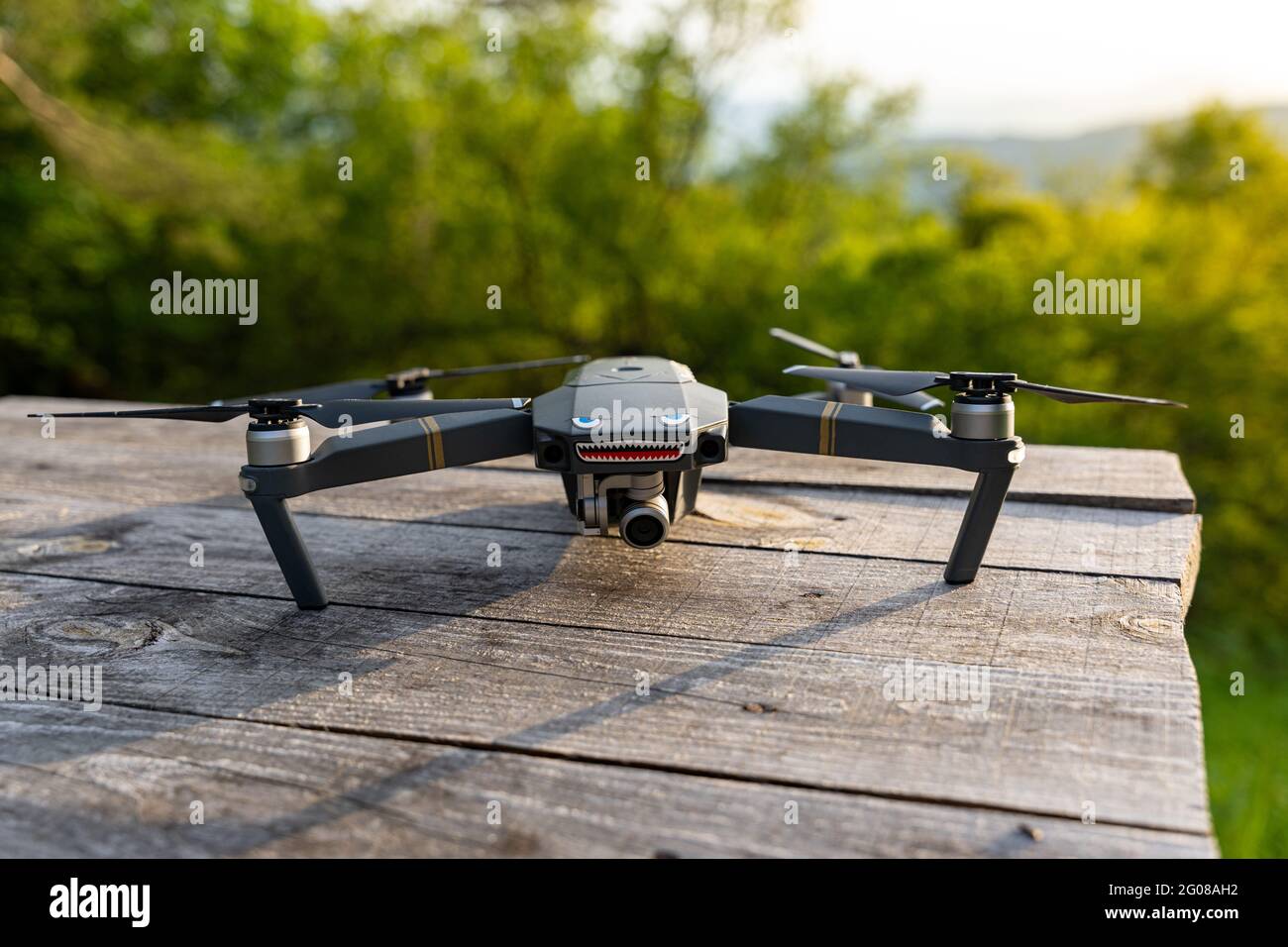 DJI Mavic pro drone with eyes and teeth on a wooden table Stock Photo