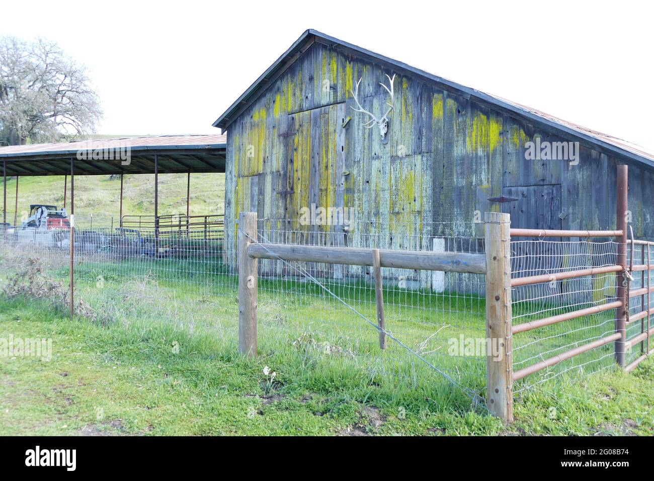 Farm with a weathered barn and corral fence Stock Photo