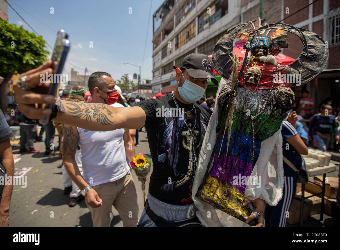 June 1, 2021, Mexico City, Mexico City, Mexico: A faithful holds a statue of Santa Muerte, while arriving at the Altar of Santa Muerte in the town of Tepito, as part of the celebrations that held on the first day of each month, hundreds of devotees attend to venerate it, give thanks for the favors and the fulfilled promises that this deity has granted them. La Santa Muerte or Santisima Muerte is a popular Mexican figure who personifies death and is an object of worship, the devotees of her are usually perceived as people associated with crime, gang activity, prostitution, drug trafficking. On Stock Photo