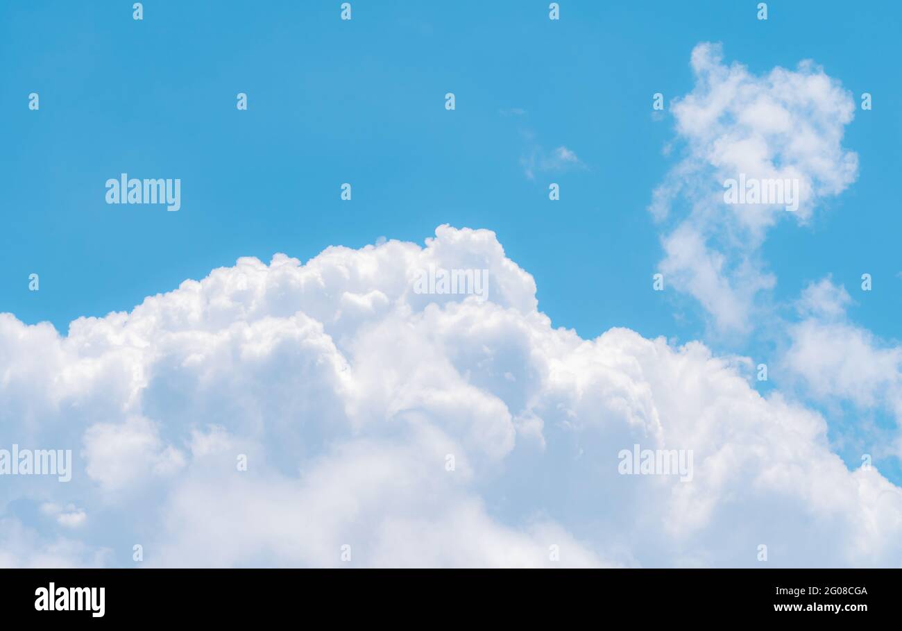 White fluffy clouds on blue sky. Soft touch feeling like cotton. White puffy cloudscape. Beauty in nature. Close-up white cumulus clouds texture. Stock Photo