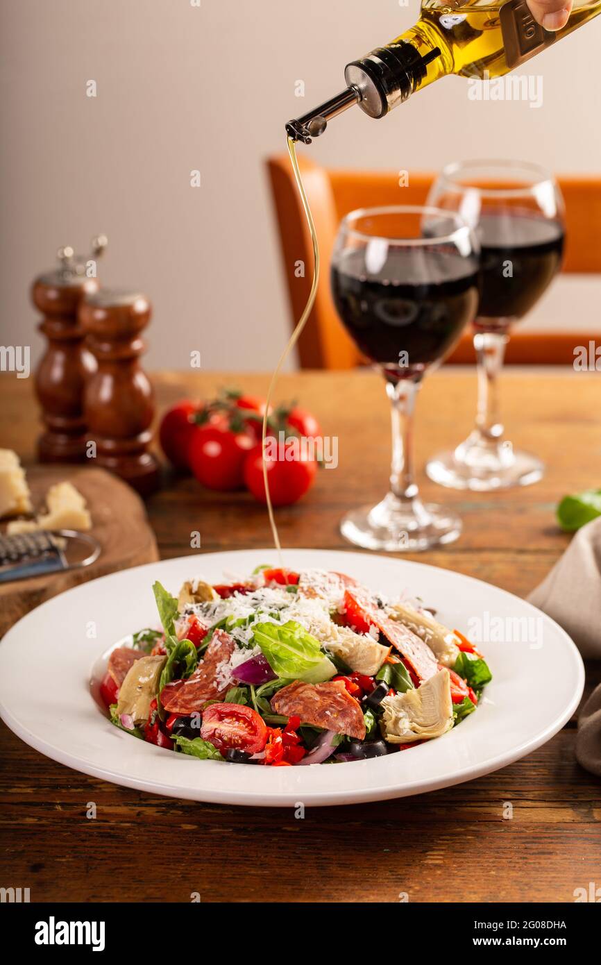 Italian antipasto salad with salami, artichoke hearts and olives Stock