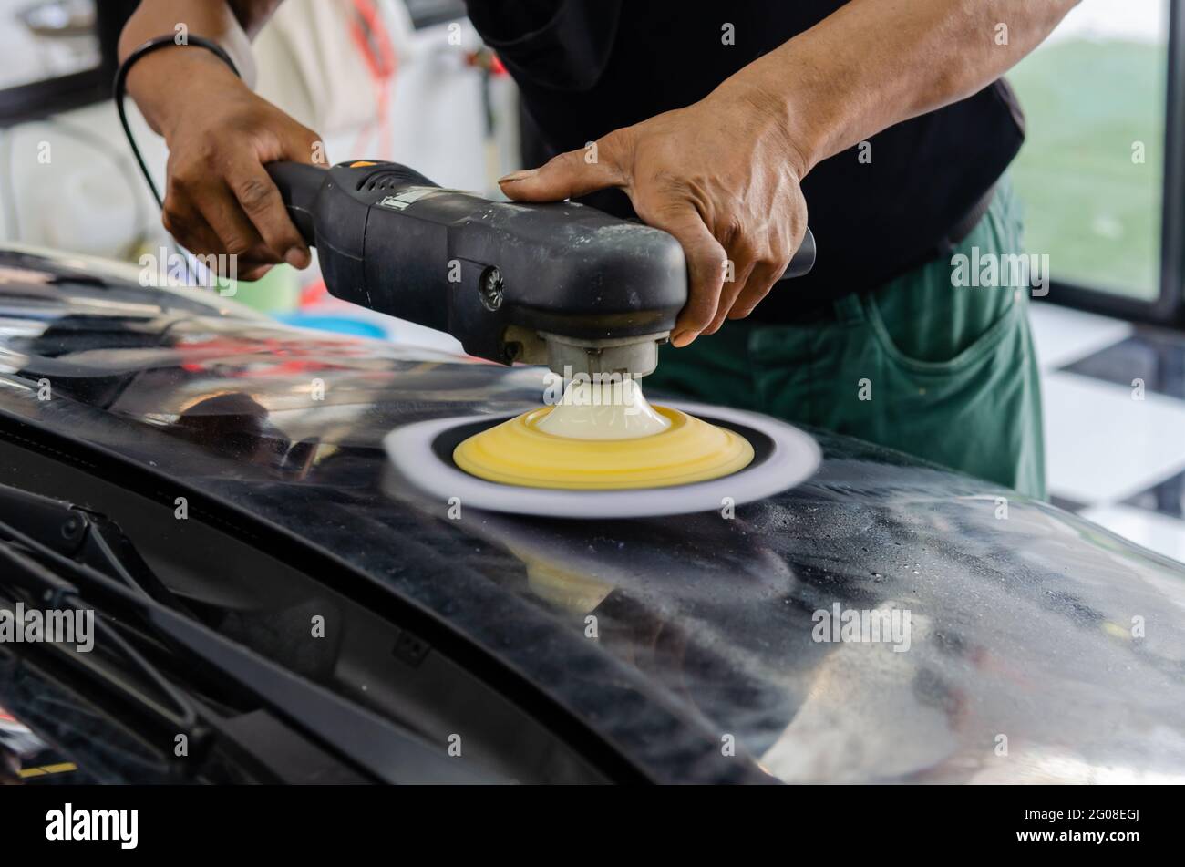 Car detailing Man working on polishing and caring the exterior with