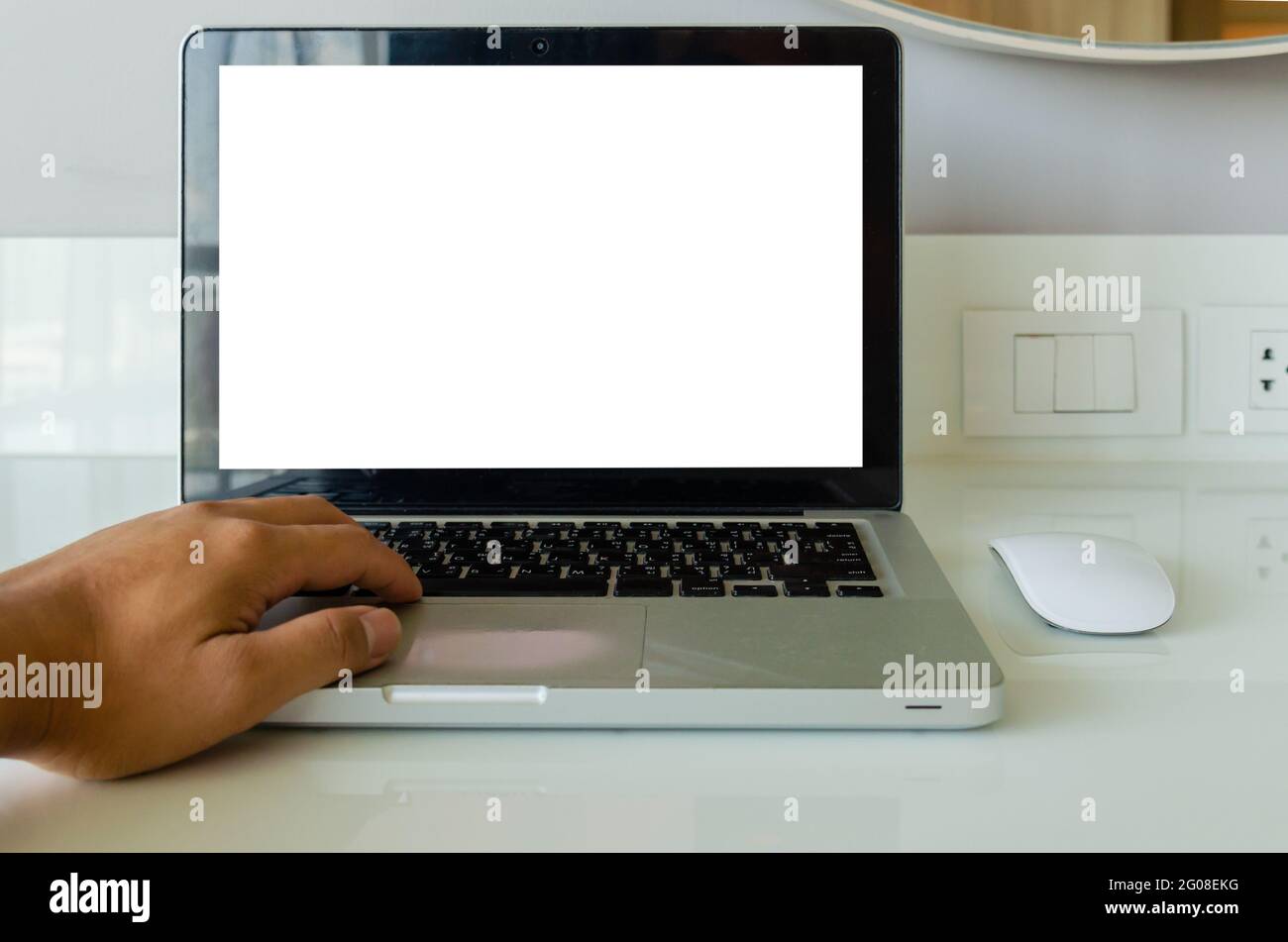 hand on keyboard computer laptop mock up and mouse white blank screen for advertising text on table. Stock Photo