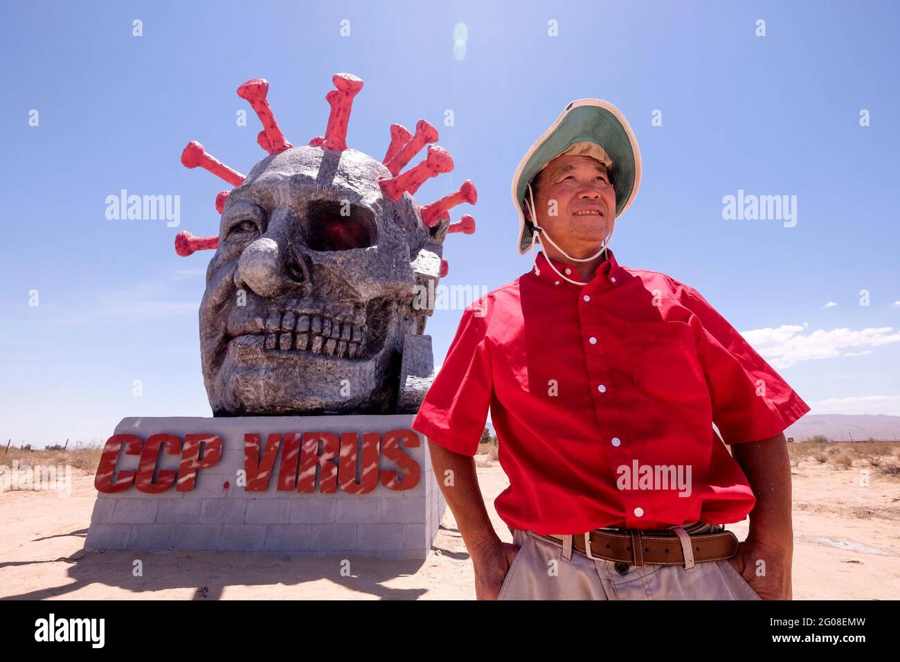 Los Angeles, California, USA. 1st June, 2021. Chinese-born dissident and sculptor Chen Weiming poses with his new work, the coronavirus sculpture 'CCP VIRUS' at the Liberty Sculpture Park in Yermo, California, on June 1, 2021. is seen at the Liberty Sculpture Park in Yermo, California, on June 1, 2021. Credit: Ringo Chiu/ZUMA Wire/Alamy Live News Stock Photo