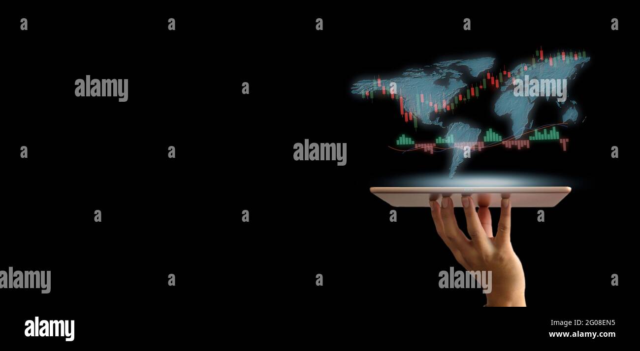 Stock market trading concept with a digital tablet businessmen holding hand on virtual screen. Business finance and graph with world map on dark backg Stock Photo