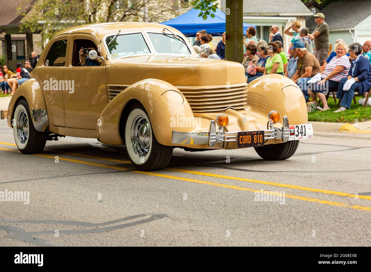 A yellow 1936 Cord 810 sedan passes through Auburn, Indiana during the 2019 Auburn Cord Duesenberg Festival Parade. Stock Photo