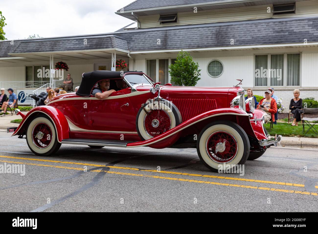 A red Auburn Speedster Boattail roadster passes through Auburn, Indiana ...