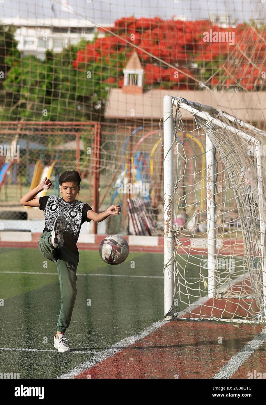 Cairo, Egypt. 1st June, 2021. A trainee participates in a football training program conducted by Manchester United Sports Academy of Egypt at the Maadi Island Park of Cairo, Egypt, June 1, 2021. Manchester United Sports Academy of Egypt aims to teach local children football skills through international training programs and qualify them for admission to professional football clubs. Credit: Wang Dongzhen/Xinhua/Alamy Live News Stock Photo