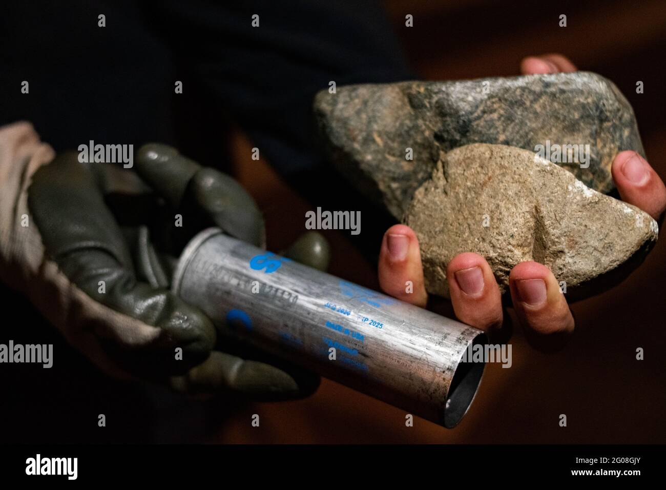 Medellin, Antioquia, Colombia. 31st May, 2021. A demonstrator holds rocks and a canister of CS Tear gas made in the United States of America as a group of hooded demonstrators clashes with Colombia's riot police (ESMAD) in Medellin, Colombia during the on going anti government protests against Presiden Ivan Duque's tax and health reform and police brutality and unrest that leaves at least 70 dead during the past month, in Medellin, Colombia on May 31, 2021. Credit: Miyer Juana/LongVisual/ZUMA Wire/Alamy Live News Stock Photo