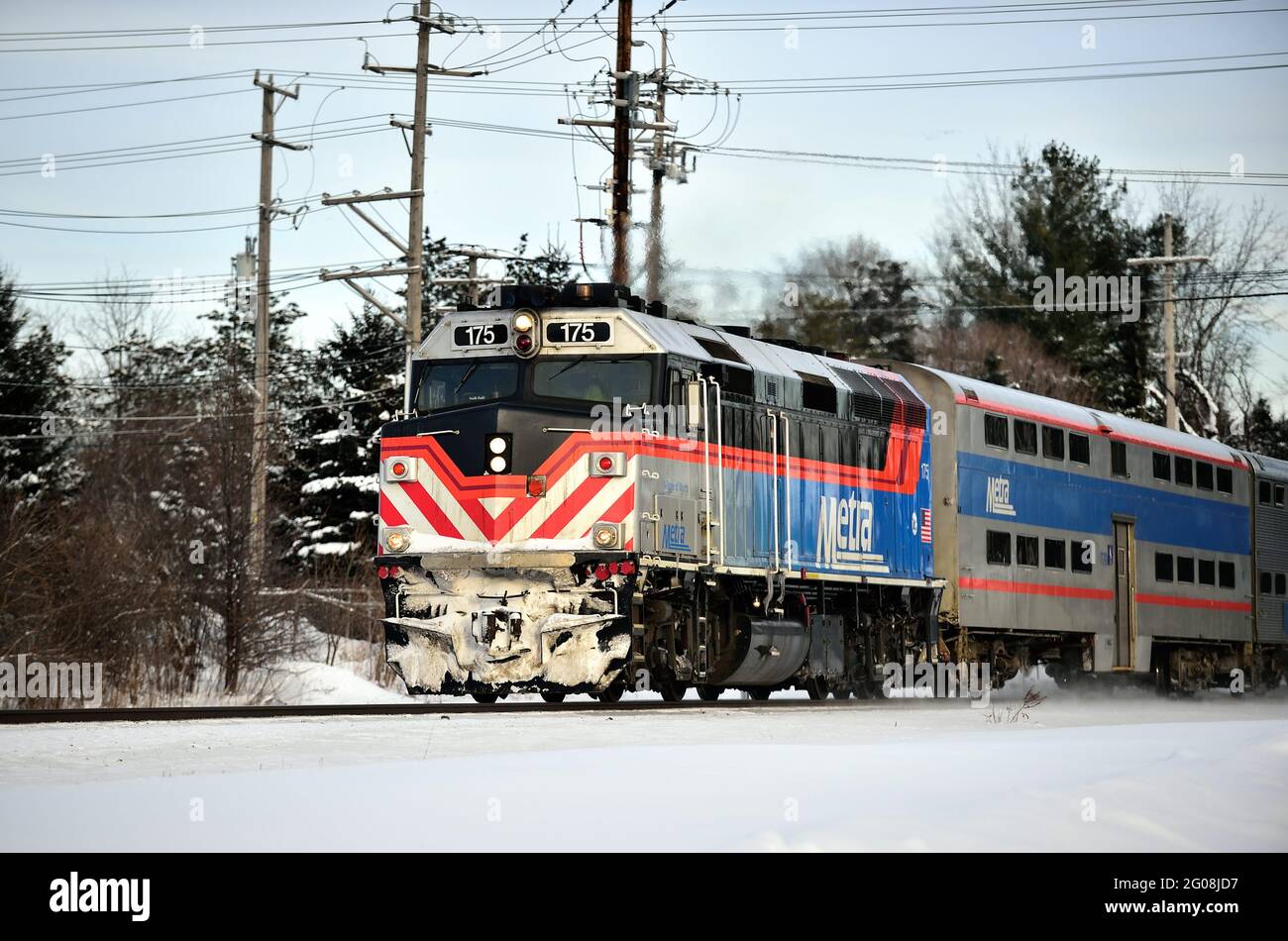 Geneva, Illinois, USA. An icecrusted Metra leads a commuter