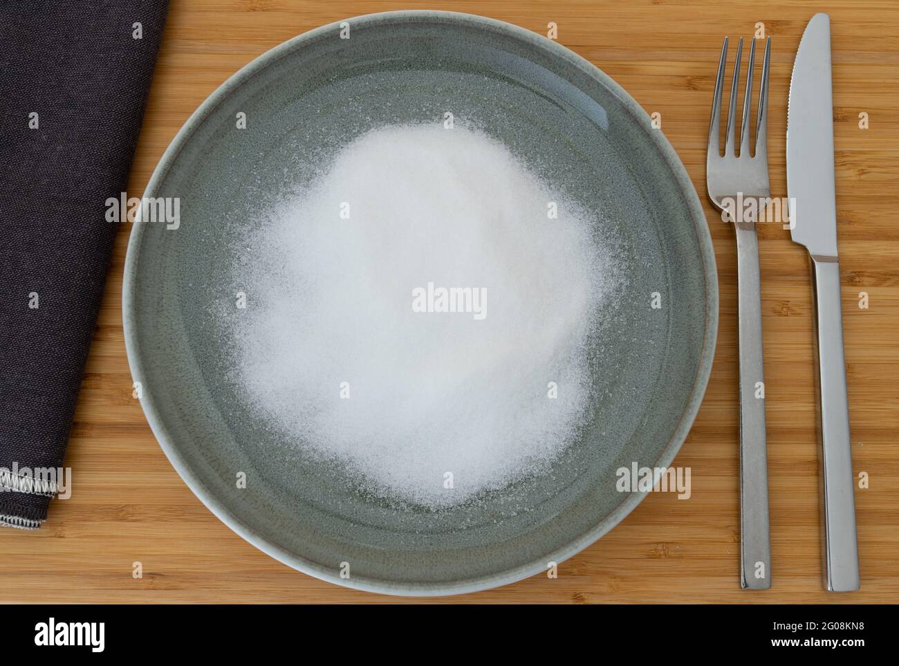 top view of white sugar on a plate as a concept for unhealthy nutrition Stock Photo