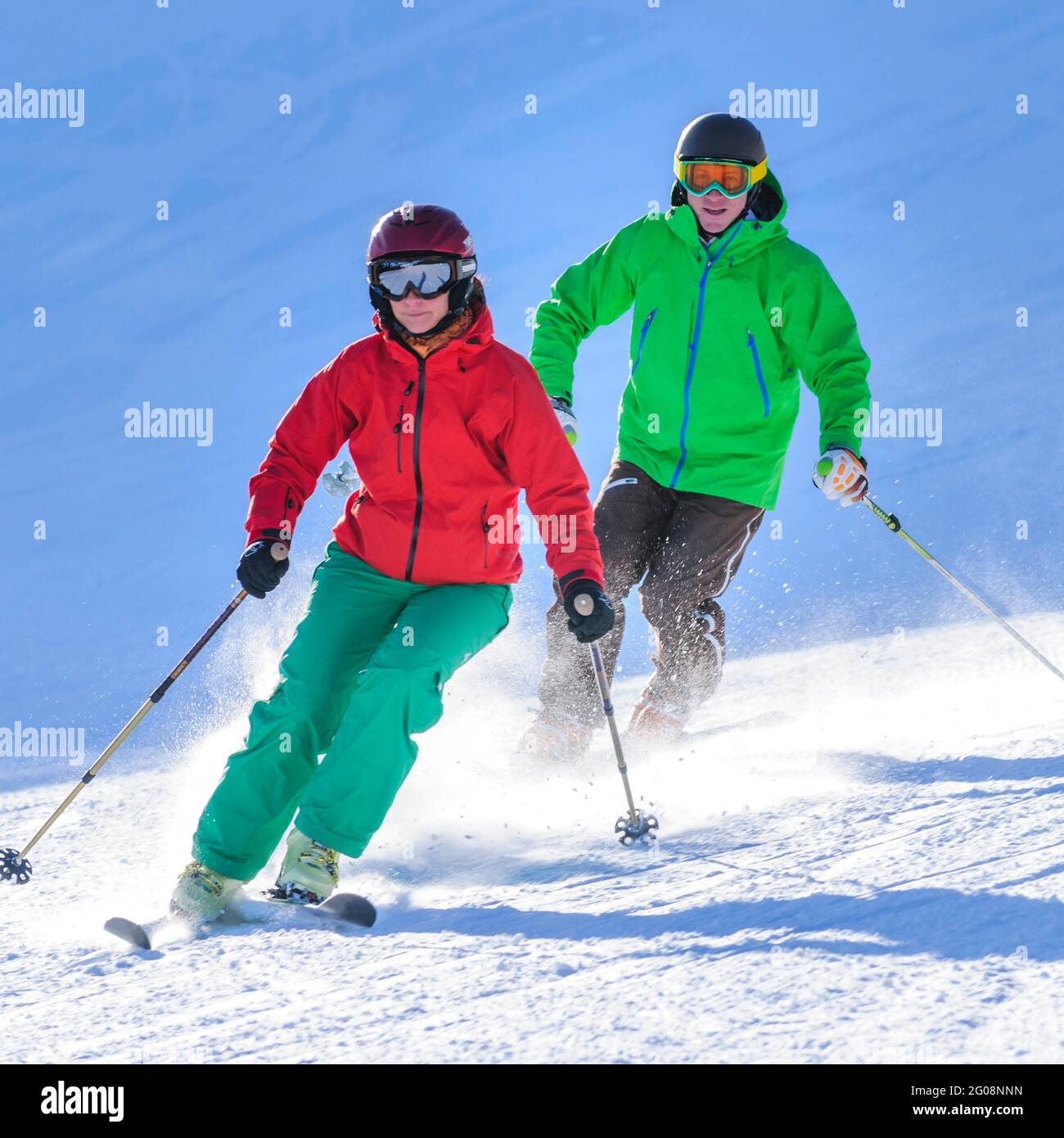 Young couple skiing together on well prepared slope Stock Photo