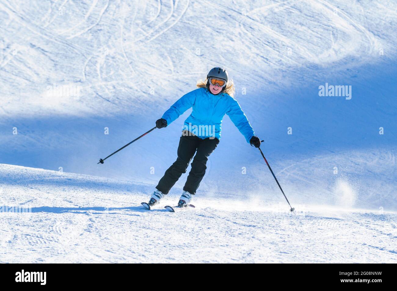Young woman skiing on slope Stock Photo
