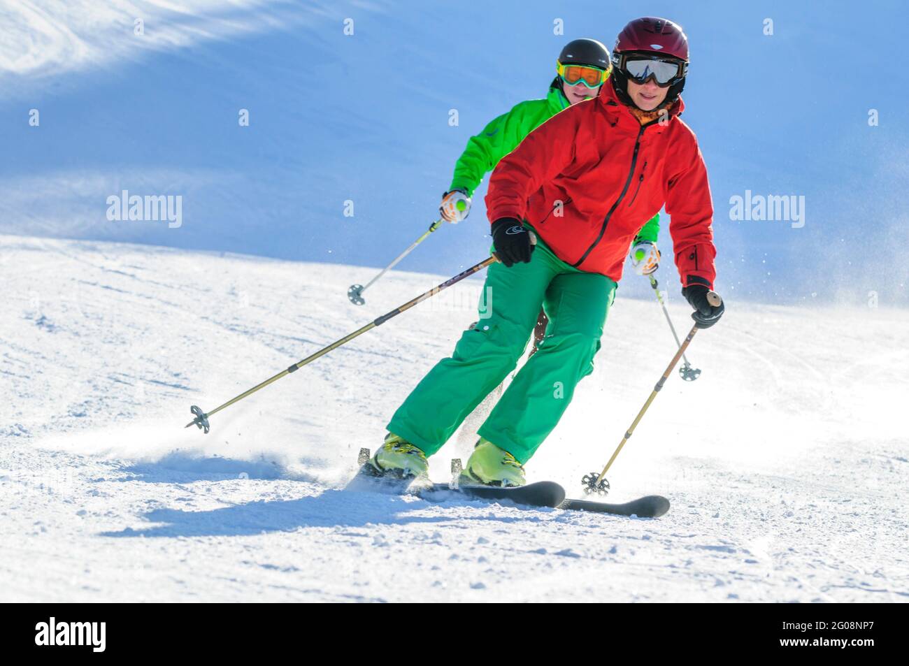 Young couple skiing together on well prepared slope Stock Photo