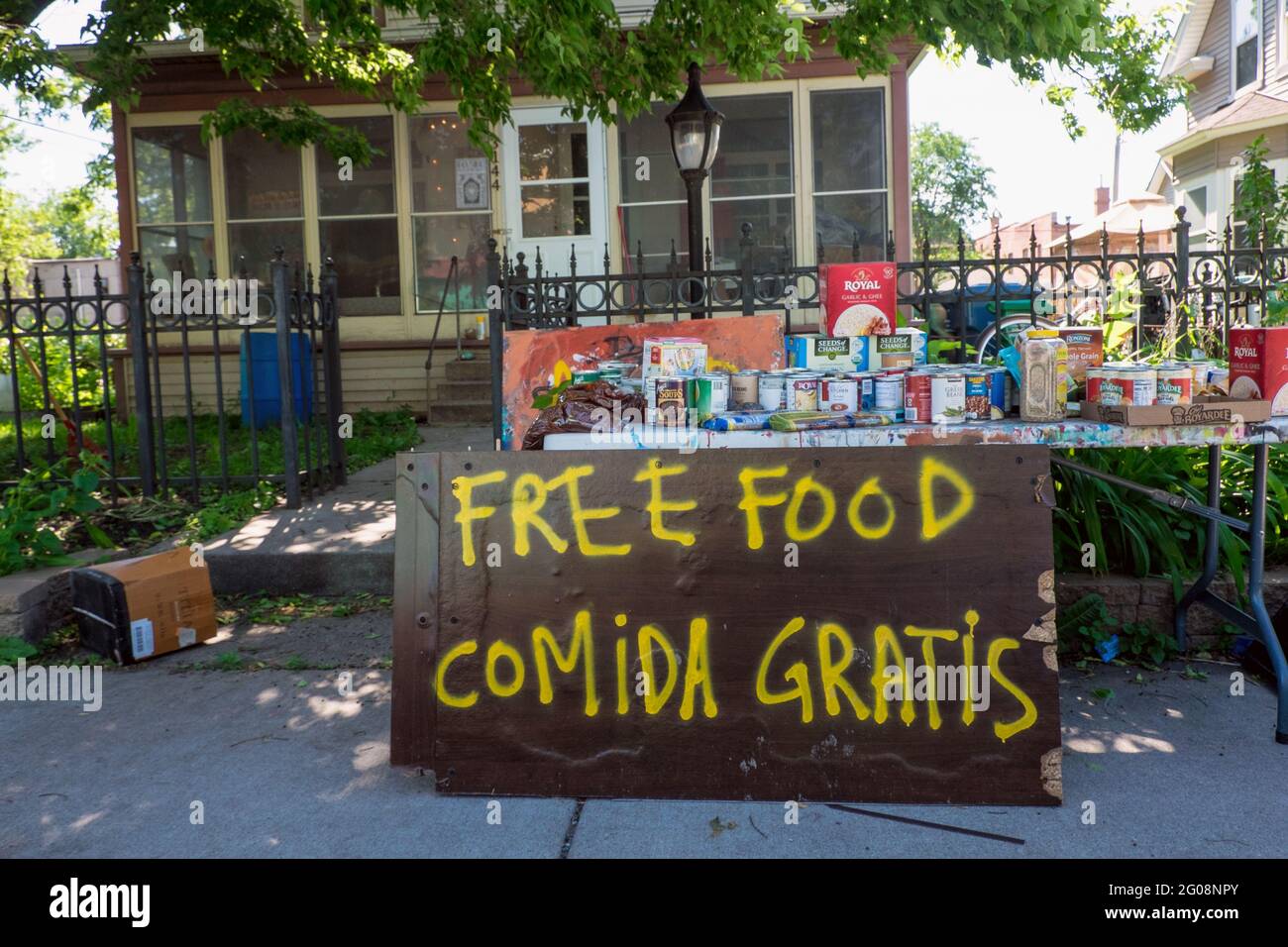 Free food on a table in a neighborhood, outdoor food bank Stock Photo