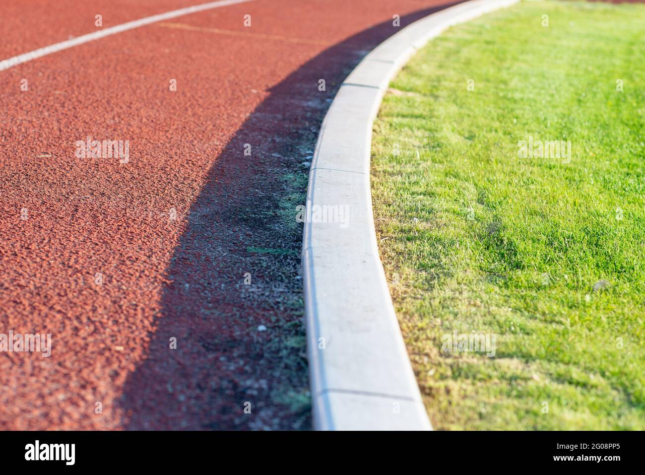 Part Red plastic track in the outdoor track and field stadium.Closeup. Stock Photo