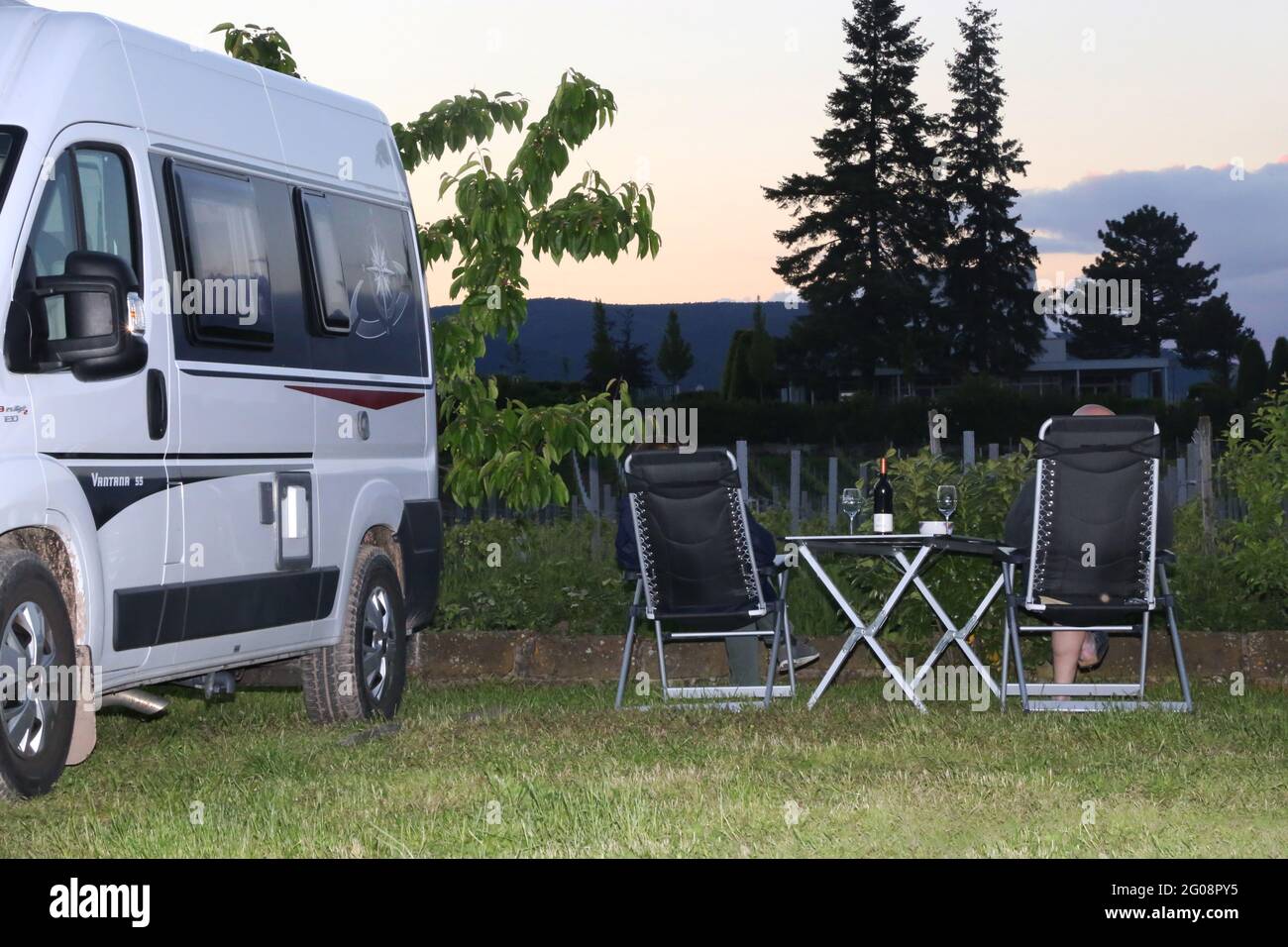 Camping holiday in Germany: Motorhome at sunset on the motorhome site of the Rehm Winery in Edesheim, Rhineland-Palatinate (Germany) Stock Photo