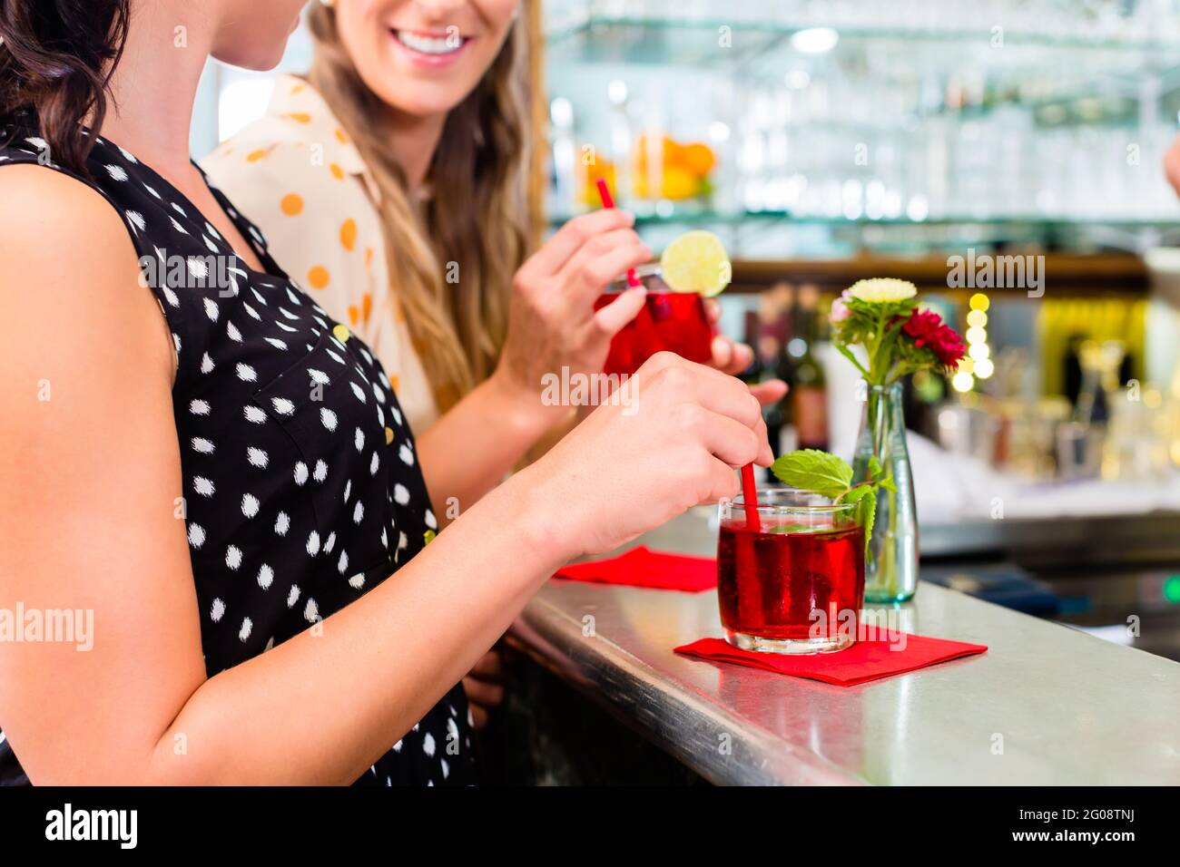 Two women friends in cafe bar drinking long drink or cocktails Stock Photo