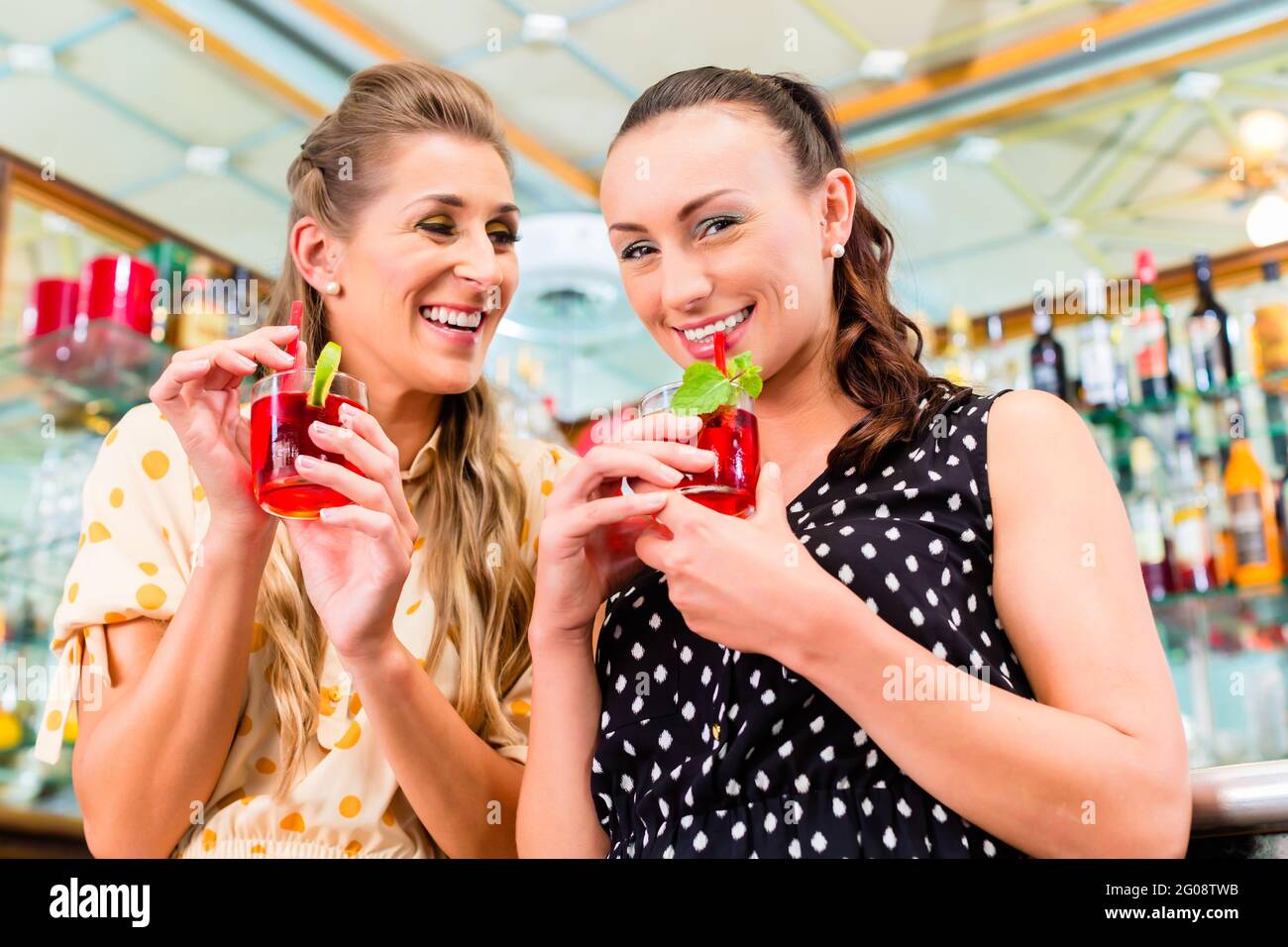Two women friends in cafe bar drinking long drink or cocktails Stock Photo