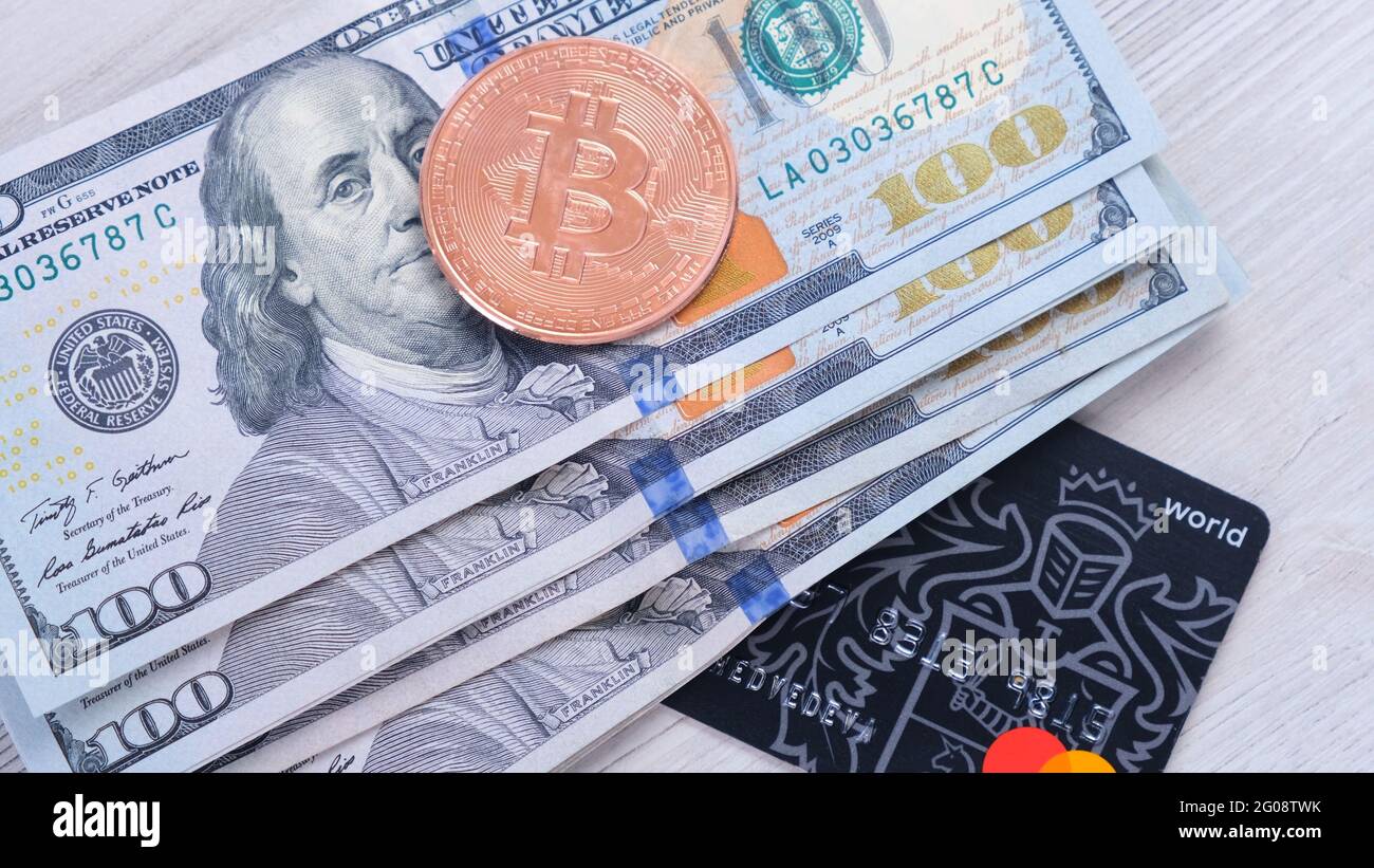 Bitcoin gold coin and a credit card and one hundred dallar bills. BTC  blockchain payments, mobile portable storing and payment, paying with crypto  Stock Photo - Alamy