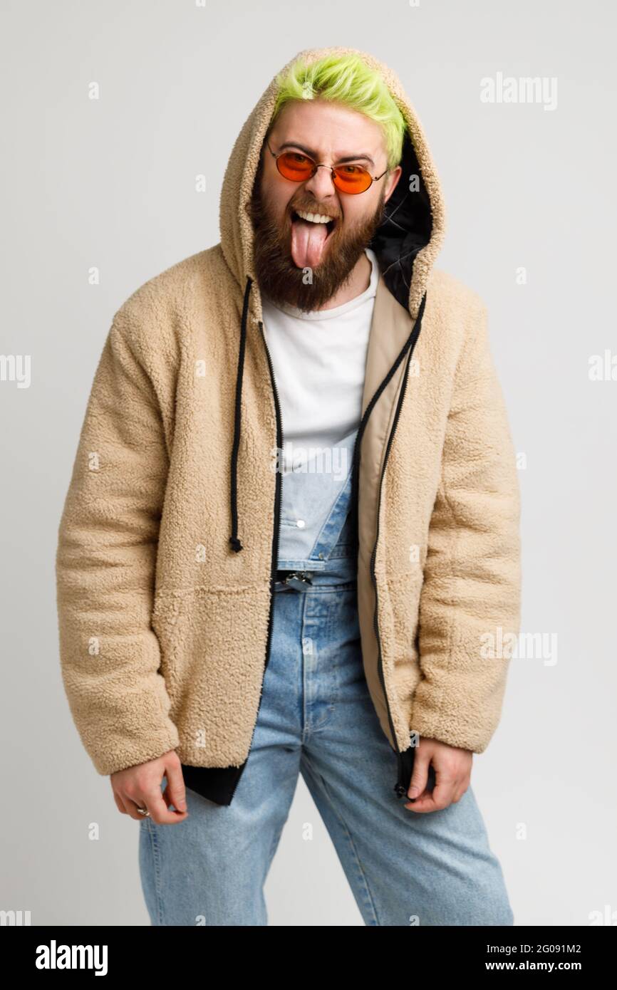 Handsome bearded man wears in stylish jacket and denim overalls fashion ...