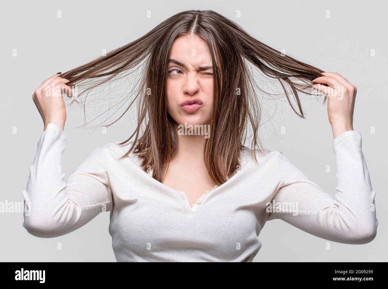 Messy hair. Brunette woman with messed hairs. Girl having a bad hair. Bad  hairs day. Frustrated woman having a bad hair. Woman having a bad hair, her  Stock Photo - Alamy