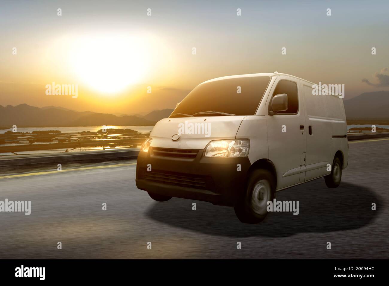 The white delivery van on the road with sunset sky background Stock ...