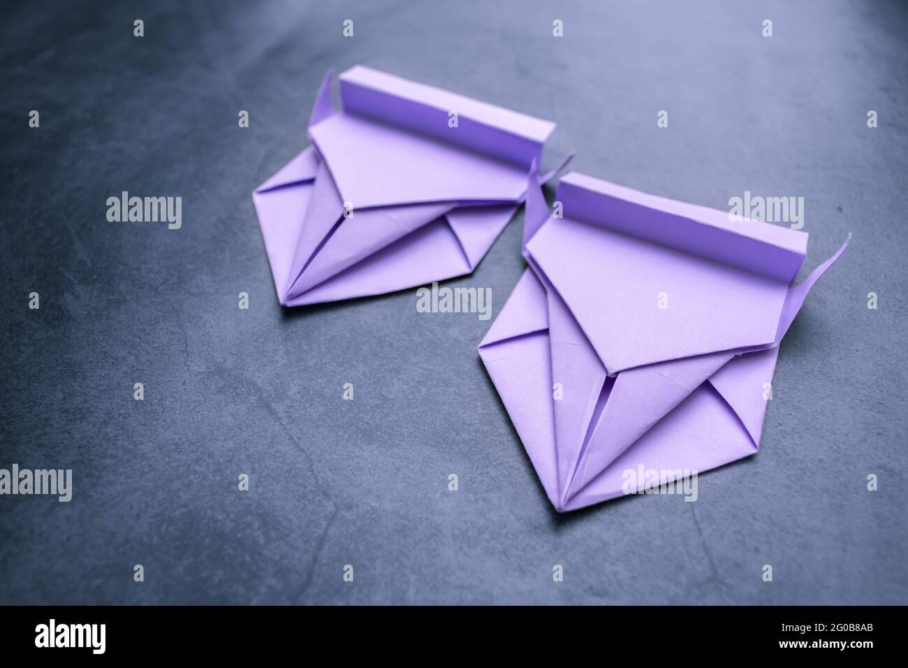 Origami, two paper cars, compete against each other on a makeshift race  track Stock Photo - Alamy