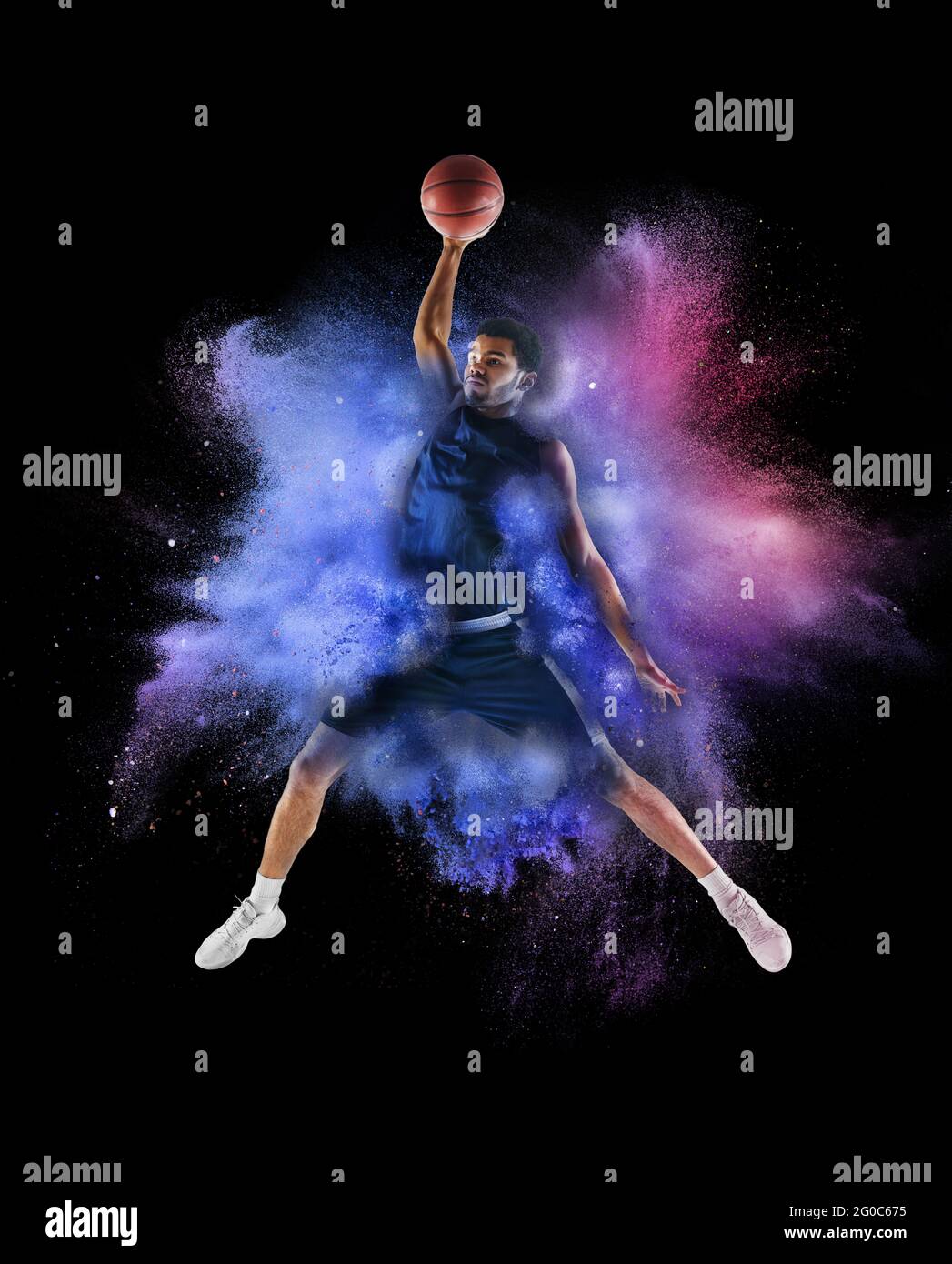 One young sportsman basketball player in explosion of colored neon