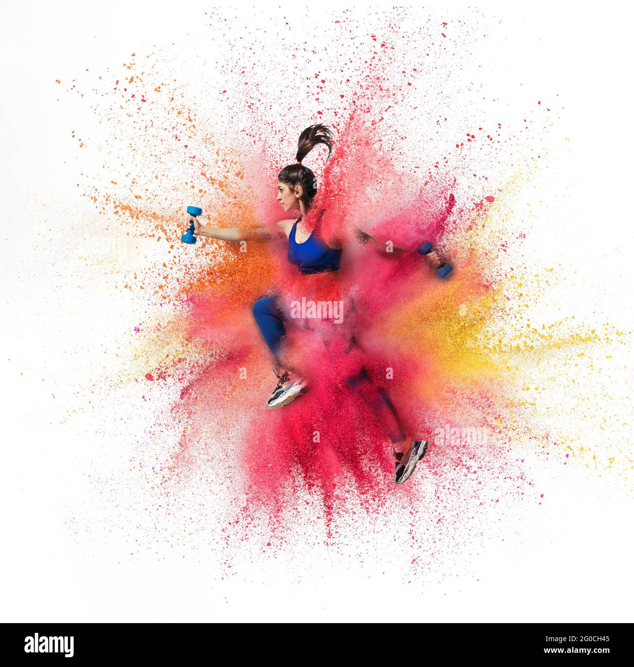 Young sportsman, female athlete running in explosion of colored powder ...