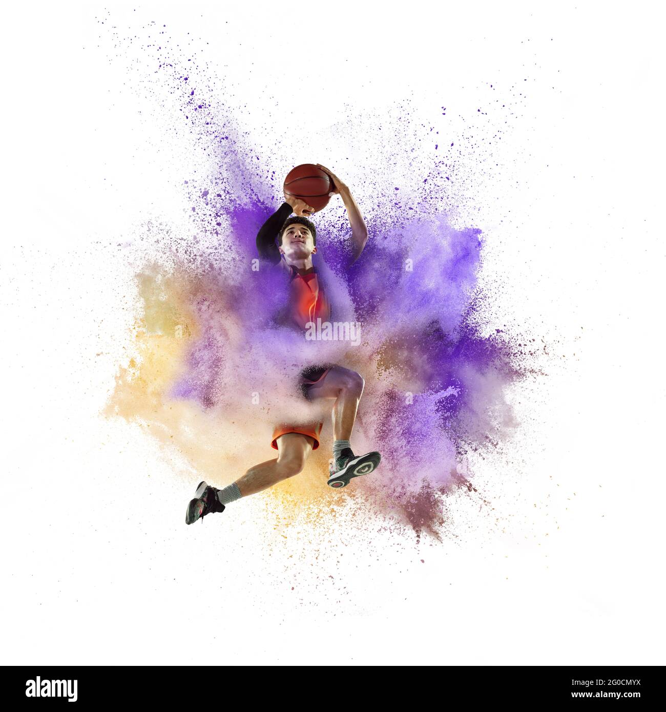 One young sportsman basketball player in explosion of colored powder