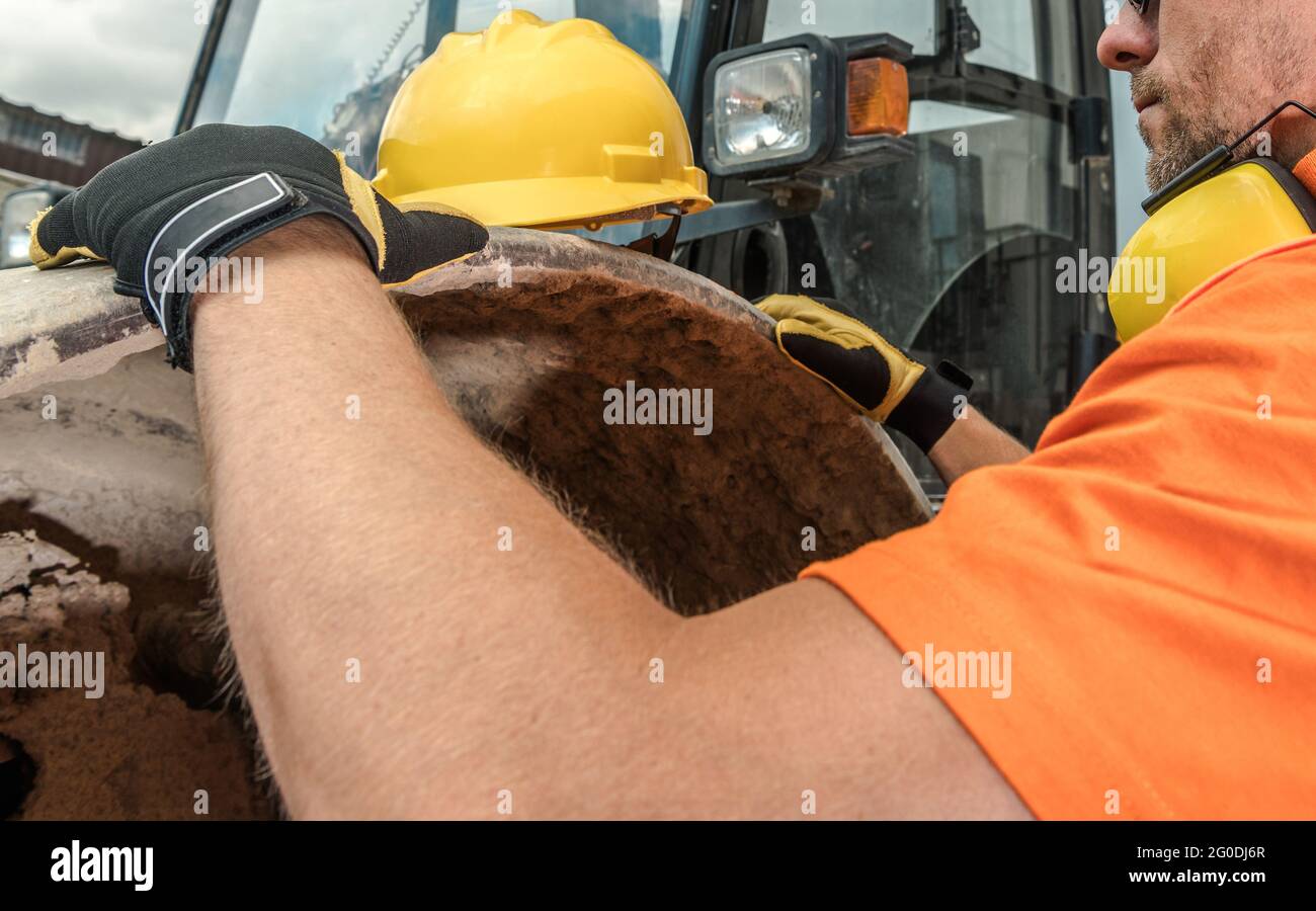 Caucasian Construction Worker Preparing For His Work. Hard Hat Area. Industrial Theme. Stock Photo