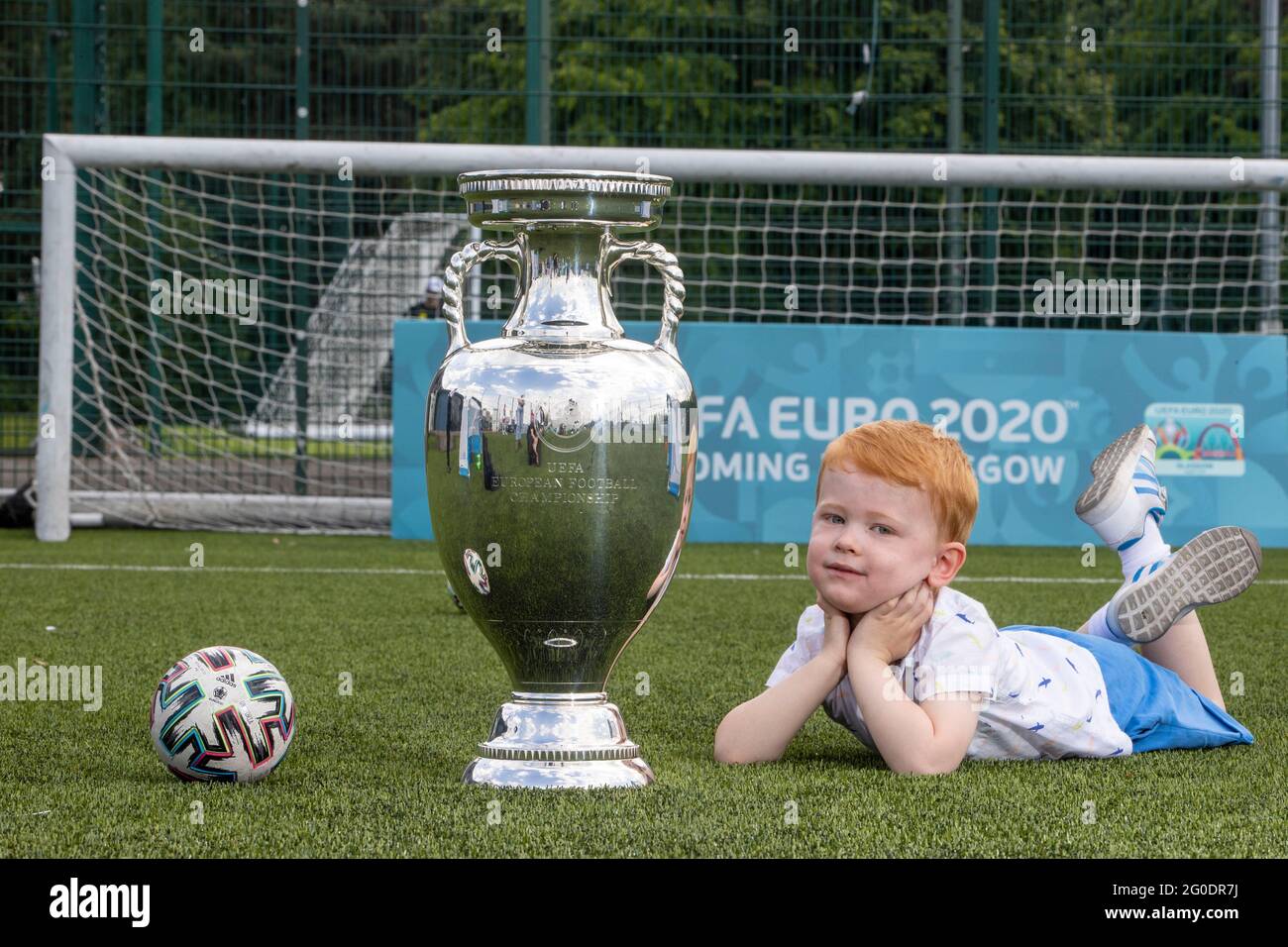Handout photo dated 02/06/2021 provided by JSHPIX of Glasgow youngster Hugo  getting their first look at Euro 2020 trophy as the Henri Delaunay Cup made  a special visit to Glasgow's Walking Football
