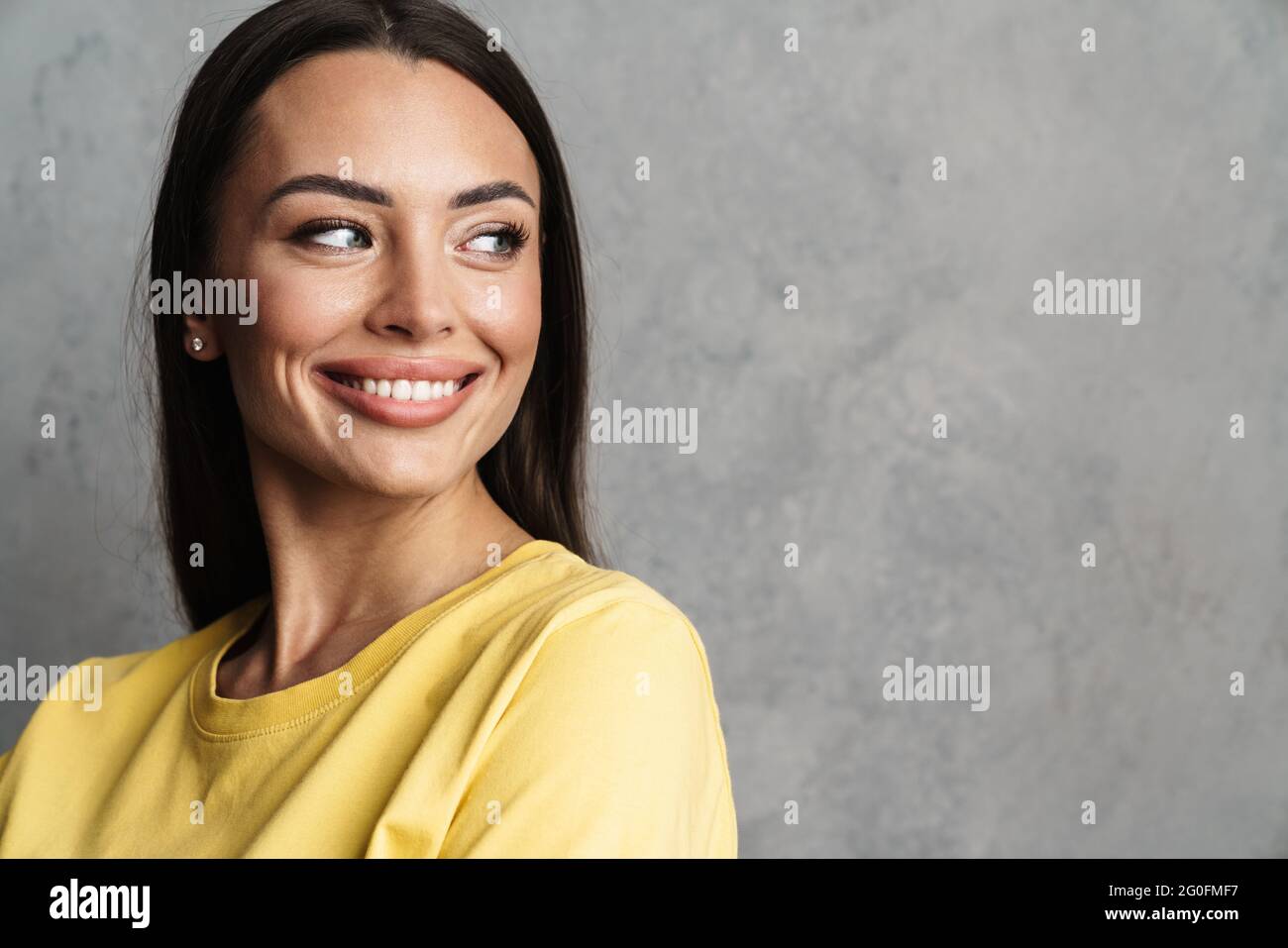 Close up of a beautiful young smiling brunette woman with long hair ...