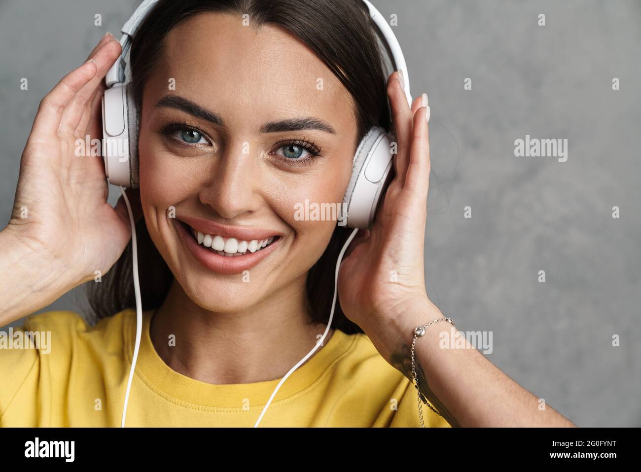 Close-up portrait of a happy young pretty girl relaxing in headphones ...