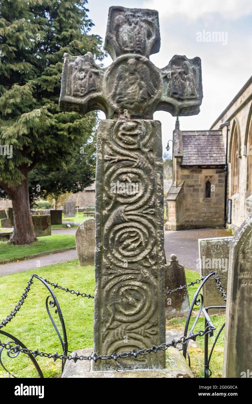 An Anglo-Saxon era stone cross in Eyam village - East face Stock Photo