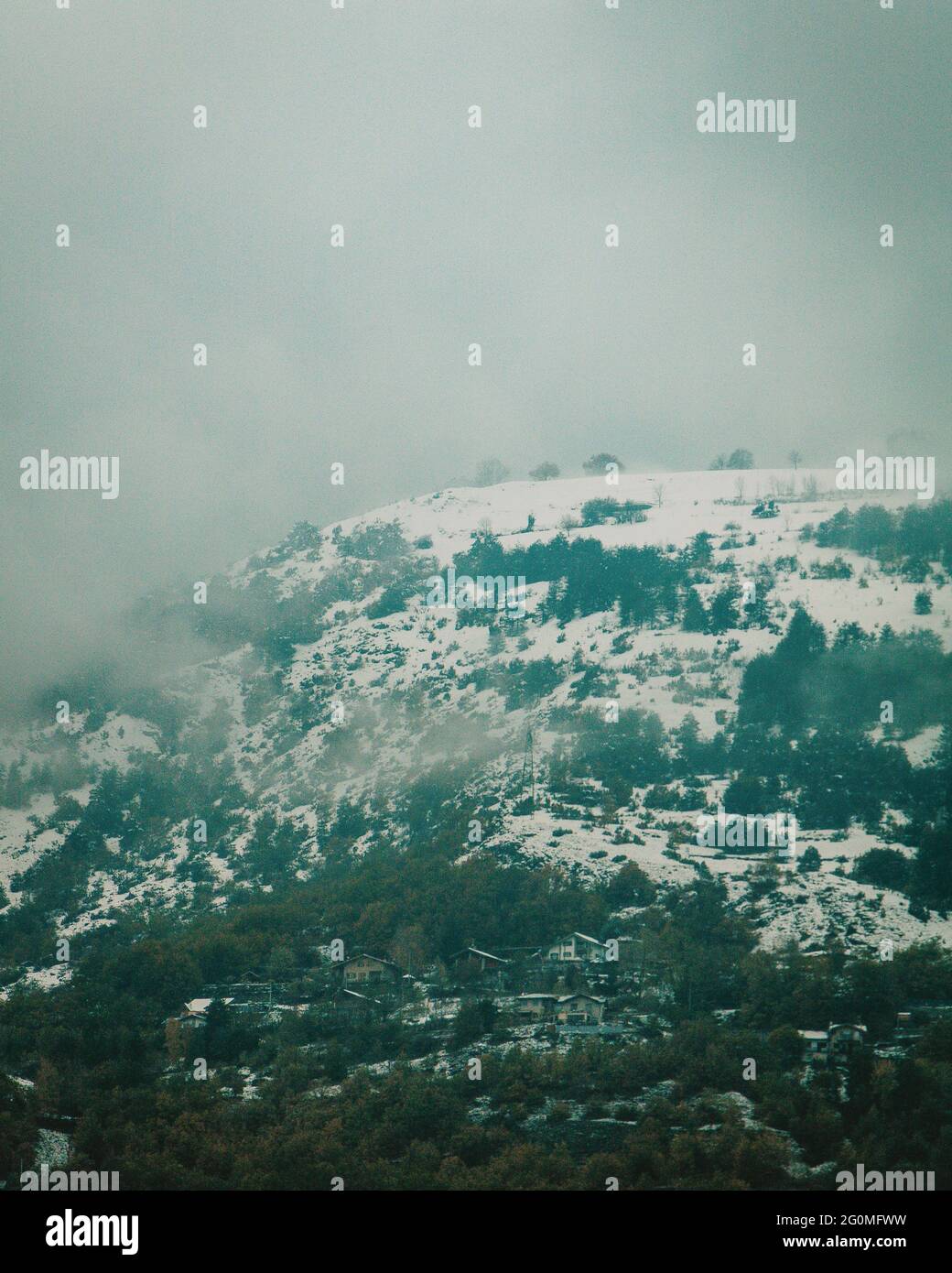 Snowy mountain on a foggy day Stock Photo - Alamy