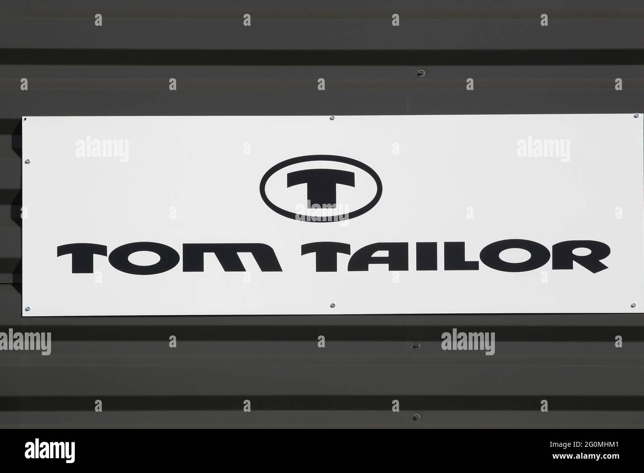 Macon, France - March 15, 2020: Tom Tailor logo on a wall. Tom Tailor is a German vertically integrated lifestyle clothing company Stock Photo