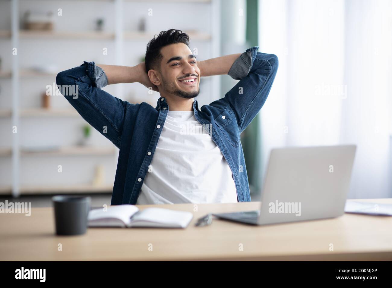 Happy arab man enjoying his job, sitting at workdesk, smiling Stock ...