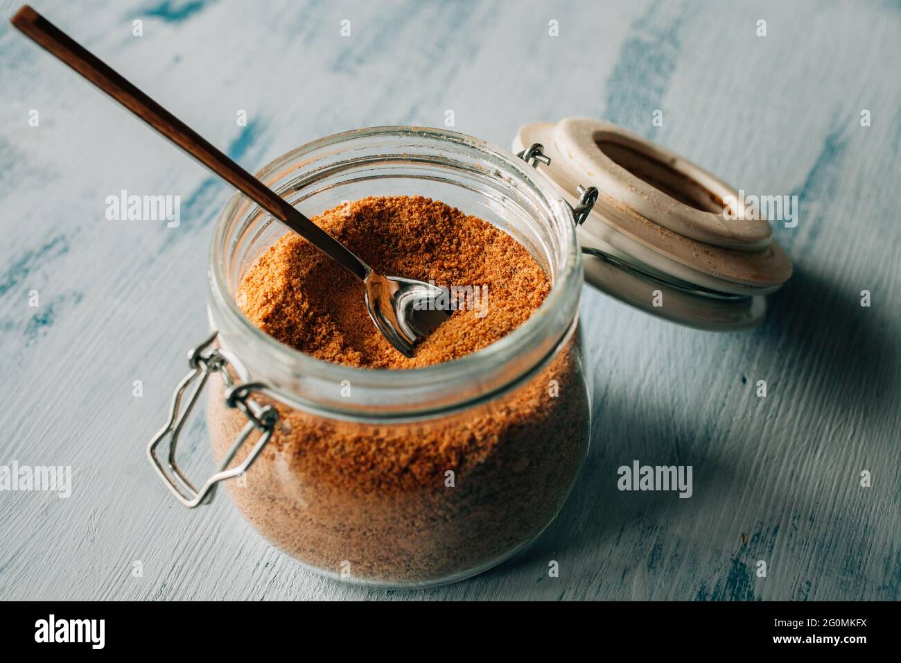 Panela sugar background. Close up view of raw cane sugar in a jar. Stock Photo